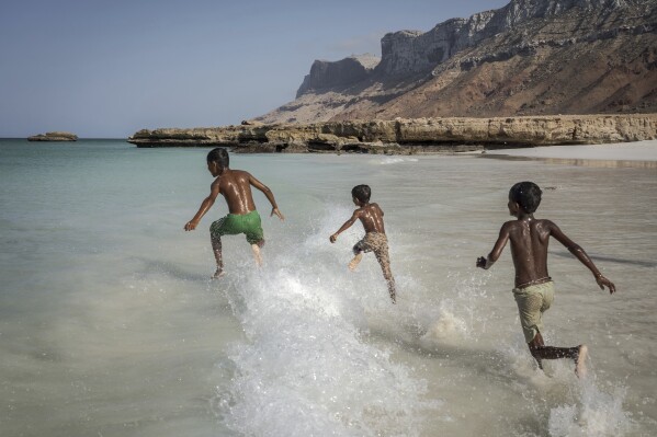 Children play in the waves on the Yemeni island of Socotra on Sept. 22, 2024. (AP Photo/Annika Hammerschlag)