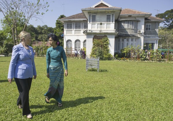 FILE - Myanmar's pro-democracy opposition leader Aung San Suu Kyi, right, and U.S. Secretary of State Hillary Rodham Clinton walk through the garden after meetings at Suu Kyi's residence in Yangon, Myanmar on Dec. 2, 2011. No bidders appeared at a court-ordered auction Wednesday, March 20, 2024 of the family home of Myanmar's imprisoned former leader, Aung San Suu Kyi, where she had been held under house arrest for nearly 15 years, legal officials said. (Saul Loeb/Pool Photo via AP, File)