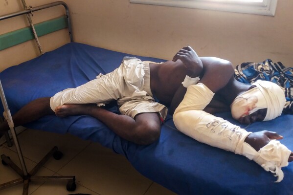 FILE - Saga Saganla, 30, from Diawely, lies on his bed at Somine Dolo hospital in Mopti, Mali, Friday June 24, 2022. Saganla survived an attack by nearly 100 jihadis on motorbikes. Top human rights groups have released new reports in which they documented cases of “war crimes” against civilians in the violent conflict in Africa’s Sahel region where rebels are increasingly fighting in communities under siege. The reports focusing on Burkina Faso and Mali were separately released this week by the Human Rights Watch and Amnesty International. (AP Photo/ Hamidou Saye, File)