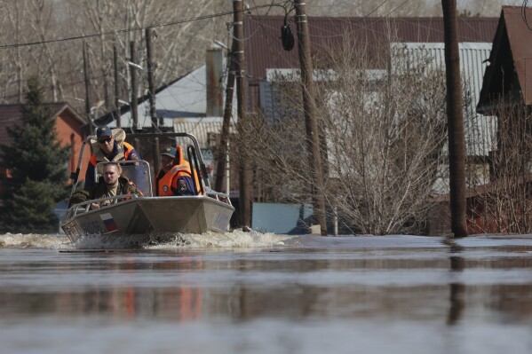 Russian Emergency Situation Ministry rescuers ride a boat to help local residents during evacuations from a flooded area in Orenburg, Russia, on Thursday, April 11, 2024. Russian officials are scrambling to help homeowners displaced by floods, as water levels have risen in the Ural River. The river's water level in the city of Orenburg was above 10 meters (33 feet) Wednesday, state news agency Ria Novosti reported, citing the regional governor. (AP Photo)