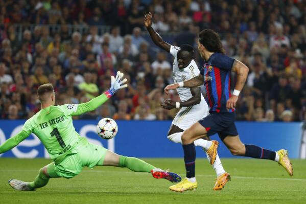 Bayern's Sadio Mane, center, scores his side's opening goal during the Champions League Group C soccer match between Barcelona and Bayern Munich at the Camp Nou stadium in Barcelona, Spain, Wednesday, Oct. 26, 2022. (AP Photo/Joan Monfort)
