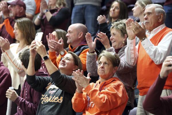 Virginia Tech fans applaud during an unveiling of an ACC championship banner in Cassell Coliseum prior to a William & Mary against Virginia Tech NCAA college basketball game in Blacksburg, Va., Sunday, Nov. 13, 2022. (Matt Gentry/The Roanoke Times via AP)
