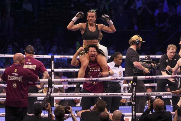 Britain's Chantelle Cameron celebrates after her win over Ireland's Katie Taylor in their light-welterweight boxing world title fight at the 3Arena in Dublin, Ireland, Saturday, May 20, 2023.(AP Photo/Peter Morrison)