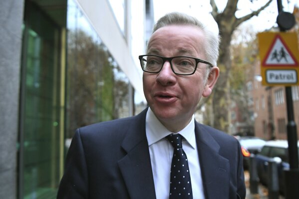 
              Britain's Environment Secretary Michael Gove arrives at his office in Westminster, London, Friday, Nov. 16, 2018. British Prime Minister Theresa May has had one piece of good news as she battles a rebellion within her Conservative Party. Gove has decided not to follow two other Cabinet ministers and resign over May's Brexit deal with the European Union, according to multiple media reports. (Victoria Jones/PA via AP)
            