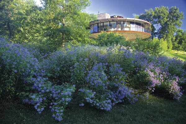 
              This photo provided by Rizzoli Press shows Round House by Richard Foster and a wild flower garden in Wilton, Conn. The photograph is featured in the book "Garden Wild: Wildflower Meadows, Prairie-Style Plantings, Rockeries, Ferneries, and Other Sustainable Designs Inspired by Nature" by Andre Baranowski. (Andre Baranowski/Rizzoli Press via AP)
            