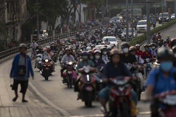 Commuters on scooters fill the street during morning rush hour in Ho Chi Minh City, Vietnam, Jan. 12, 2024. (AP Photo/Jae C. Hong)