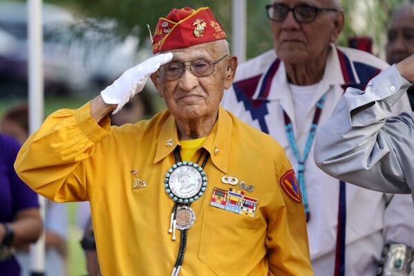 Navajo Code Talker Thomas Begay salutes during the national anthem at the Arizona State Navajo Code Talkers Day celebration, Aug. 14, 2022, in Phoenix. (AP Photo/Ross D. Franklin, File)
