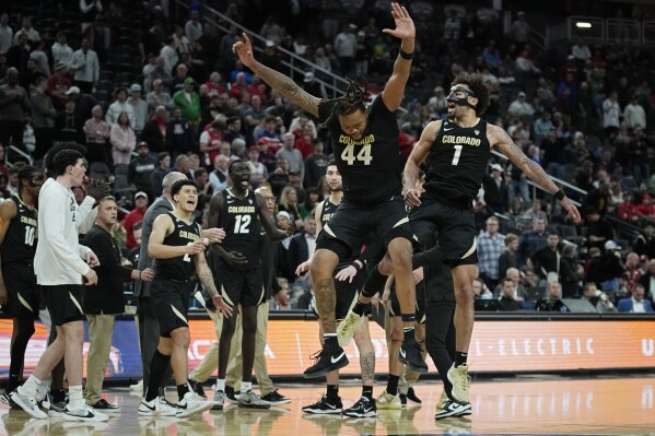 Colorado guard J'Vonne Hadley (1) and center Eddie Lampkin Jr. (44) celebrate as Colorado leads Washington State in the final seconds during the second half of an NCAA college basketball game in the semifinal round of the Pac-12 tournament Friday, March 15, 2024, in Las Vegas. (AP Photo/John Locher)
