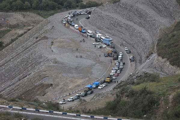 FILE - Ethnic Armenians flee Nagorno-Karabakh to Kornidzor, in Armenia's Syunik region, Tuesday, Sept. 26, 2023. Armenia and Azerbaijan have agreed to exchange prisoners of war and work toward signing a peace treaty in what the European Union is hailing as a major step toward peace in the long-troubled region. The two countries said in a joint statement Thursday, Dec. 7, 2023 that they “share the view that there is a historical chance to achieve a long-awaited peace.” (AP Photo/Vasily Krestyaninov, File)