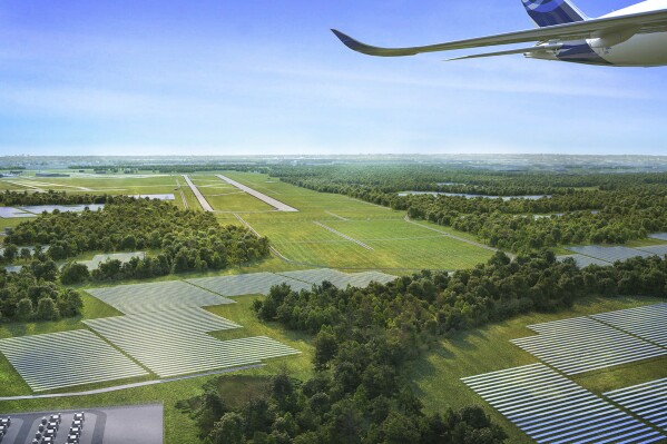 This artist rendering provided by Dominion Energy on Tuesday, Aug. 22, 2023, shows the Dulles Solar and Storage project, located in the southwest corner of Dulles International Airport in Dulles, Va. Travelers taking off and landing at Dulles International Airport outside the nation’s capital will soon see an array of 200,000 solar panels laid out near the runways, the largest renewable energy project ever built at a U. S. airport. Dominion Energy and the Metropolitan Washington Airports Authority ceremonially broke ground on the 835-acre project Tuesday. (Dominion Energy via AP)