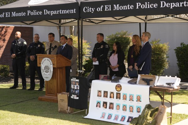 United States Attorney Martin Estrada, at podium, is joined by federal and local law enforcement officials to announce the arrests of violent street gang members involved in shootings and wide array of criminal activity, Wednesday, July 26, 2023, outside the El Monte Police Department in El Monte, Calif. (AP Photo/Damian Dovarganes)