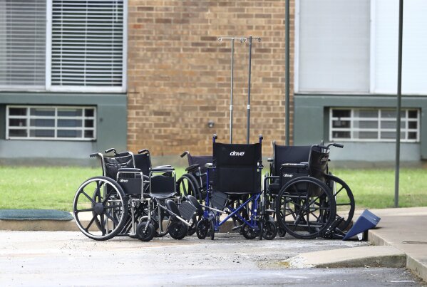 Wheelchairs are stacked up at the curb outside PruittHealth Grandview nursing home where at least 10 patients who were previously tested presumptive positive for COVID-19 have passed away on Wednesday, April 8, 2020, in Athens. The facility continues to operate at an alert code red status following enhanced infectious disease protocol despite the deaths. (Curtis Compton/Atlanta Journal-Constitution via AP)