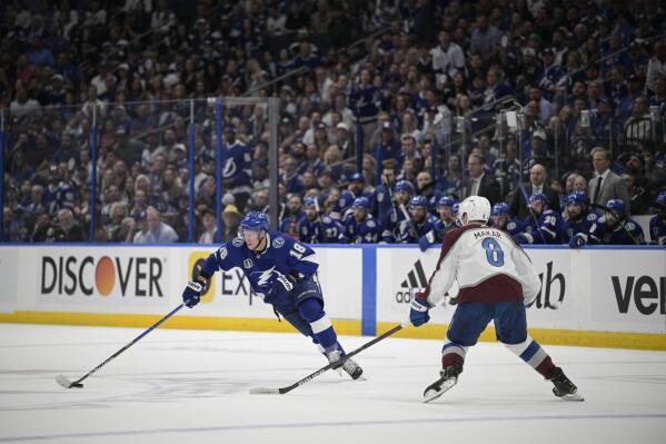 Tampa Bay Lightning left wing Ondrej Palat (18) controls the puck against Colorado Avalanche defenseman Cale Makar (8) during the first period of Game 3 of the NHL hockey Stanley Cup Final on Monday, June 20, 2022, in Tampa, Fla. (AP Photo/Phelan M. Ebenhack)