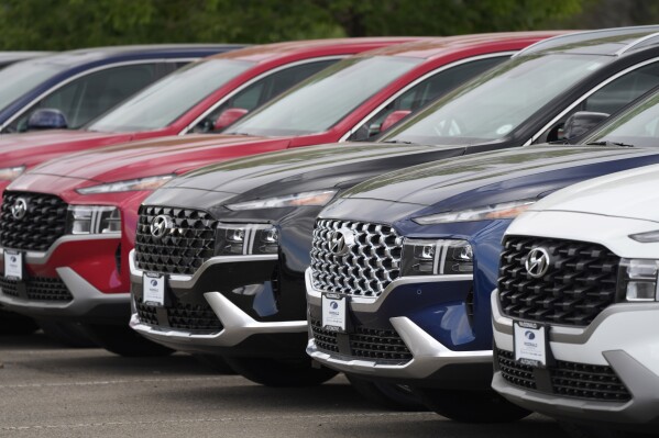 FILE - A line of 2022 Santa Fe SUV's sit outside a Hyundai dealership on Sept. 12, 2021, in Littleton, Colo. Nearly 3.4 million Hyundai and Kia vehicles in the U.S. are under recall due to the risk of engine compartment fires. (AP Photo/David Zalubowski, File)