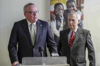 FILE - In this March 18, 2019 file photo, James Carroll, director of the Office of National Drug Control Policy, speaks at Volunteers of America as Senate Majority Leader Mitch McConnell looks on in Louisville, Ky.  Drug overdose deaths surged by nearly 50% last year in Kentucky, where opioid addiction mixed with pandemic-related stress to set a new record for tragedy and grief from a crisis that continues to ravage the region, a new report said, Wednesday, Aug. 4, 2021.(Michael Clevenger/Courier Journal via AP, File)