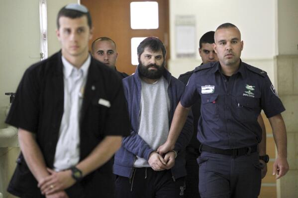 FILE - Yosef Haim Ben David, center, arrives at court in Jerusalem on March 22, 2016, during his murder trial in the death of a 16-year-old Palestinian boy. An Israeli group raising funds for Jewish radicals convicted in some of the country’s most notorious hate crimes, including Ben David, is collecting tax-exempt donations from Americans, according to an investigation by the AP and the Israeli investigative platform Shomrim. (AP Photo/Mahmoud Illean, File)