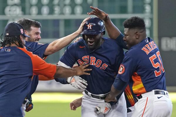 Houston Astros' Yordan Alvarez, center, celebrates with teammates after hitting a game-winning RBI-single against the Seattle Mariners during the 10th inning of a baseball game Sunday, July 31, 2022, in Houston. The Astros won 3-2 in 10 innings. (AP Photo/David J. Phillip)