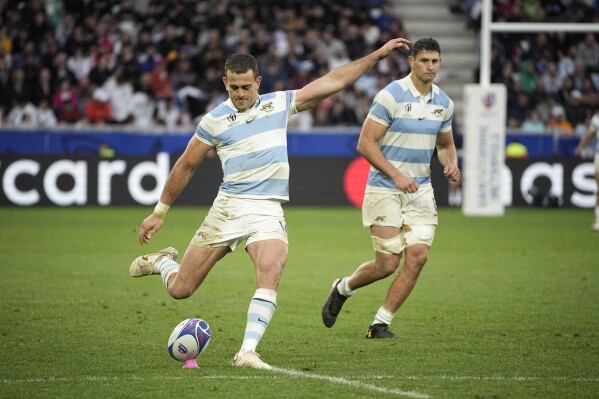 Argentina's Emiliano Boffelli, left, kicks a conversion as teammate Juan Martin Gonzalez watches on during the Rugby World Cup Pool D match between Argentina and Samoa at the Stade Geoffroy Guichard in Saint-Etienne, France, Friday, Sept. 22, 2023. (AP Photo/Laurent Cipriani)