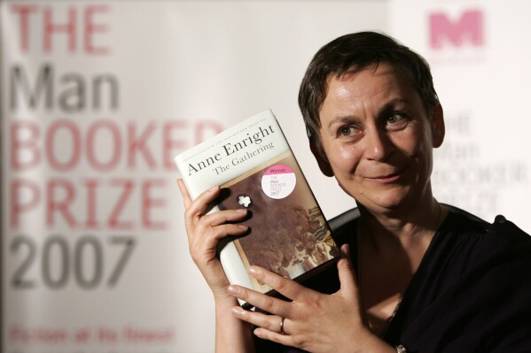 FILE - Irish writer Anne Enright holds a copy of her book after she won the Man Booker fiction prize for "The Gathering," an uncompromising portrait of a troubled family that its author called the literary equivalent of a Hollywood weepie, in London on Oct. 16 2007. Novels that give voice to the often unheard stories of migrants around the world are among the nominees for the 2024 Women’s Prize for Fiction. The 16-book long list announced Tuesday, April 24, 2024, for the 30,000 pound ($38,000) award includes works by writers from Ghana, Barbados, Britain, the United States, Ireland, South Korea and Australia. One of the most published authors is Ireland’s Anne Enright, nominated for her seventh novel, “The Wren, The Wren.” (AP Photo/Alastair Grant, File)