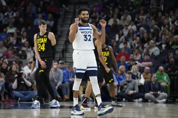 Minnesota Timberwolves center Karl-Anthony Towns (32) gestures after a foul called on Utah Jazz guard Talen Horton-Tucker during the first half of an NBA basketball game Thursday, Nov. 30, 2023, in Minneapolis. (AP Photo/Abbie Parr)
