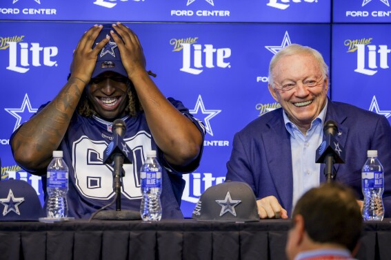 Dallas Cowboys owner Jerry Jones, right, speaks at an NFL football news conference announcing first round draft pick Tyler Guyton, left, in Frisco, Texas, Friday, April 26, 2024. (AP Photo/Gareth Patterson)