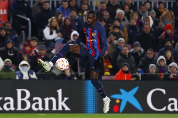 FILE - Barcelona's Ousmane Dembele controls the ball to score his side's opening goal during the Spanish Copa del Rey soccer match between Barcelona and Real Sociedad at the Camp Nou stadium, in Barcelona, Spain, Wednesday, Jan. 25, 2023. Barcelona has reached deal to send France forward Ousmane Dembélé to Paris Saint-Germain, the Spanish club said Saturday, Aug. 12, 2023. (AP Photo/Joan Monfort, File)