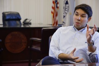 
              FILE- In this Jan. 6, 2016, file photo newly elected Fall River Mayor Jasiel Correia talks in his city hall office in Fall River, Mass. A Massachusetts mayor was arrested Thursday, Oct. 11, 2018, and charged with defrauding investors in a company he formed out of more than $230,000 and using the funds to enhance his political career and pay for a lavish lifestyle, federal prosecutors said. (AP Photo/Stephan Savoia, File)
            