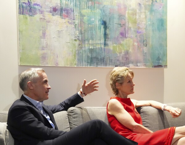 Canada's new Prime Minister and Liberal Leader Mark Carney and his wife Diana Fox Carney take in the results on election night in Ottawa, Ontario, Monday, April 28, 2025. (Sean Kilpatrick/The Canadian Press via AP)