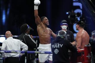 FILE - In this Saturday, Dec. 12, 2020 file photo, World Heavyweight boxing champion Britain's Anthony Joshua celebrates after beating challenger Bulgaria's Kubrat Pulev to win their Heavyweight title fight at Wembley Arena in London.  Joshua will defend his WBA, IBF and WBO heavyweight titles against former undisputed world cruiserweight champion Oleksandr Usyk at Tottenham Hotspur Stadium on Sept. 25. The fight pits two 2012 London Olympic gold medallists against each other. Joshua topped the podium in the super-heavyweight division and Usyk reigned supreme in the heavyweight bracket. (Andrew Couldridge/Pool via AP, File)
