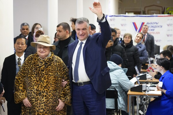 Leonid Slutsky, leader of the Liberal Democratic Party of Russia (LDPR) and candidate in the presidential election, and his mother Natalya thank journalists after voting during a presidential election in Moscow, Russia, Saturday, March 16, 2024. Voters in Russia headed to the polls for a presidential election that was all but certain to extend President Vladimir Putin's rule after he clamped down on dissent. (AP Photo/Alexander Zemlianichenko)