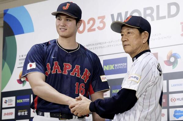 Shohei Ohtani, left, of Los Angeles Angels, shakes hands with Japan's manager Hideki Kuriyama, right, during a press conference in Tokyo, Japan, Friday, Jan. 6, 2023. Japan officials on Friday named 12 members of the World ,Baseball Classic team that will represent the country. The World Baseball Classic will be played March 8-21.(Iori Sagisawa/Kyodo News via AP)