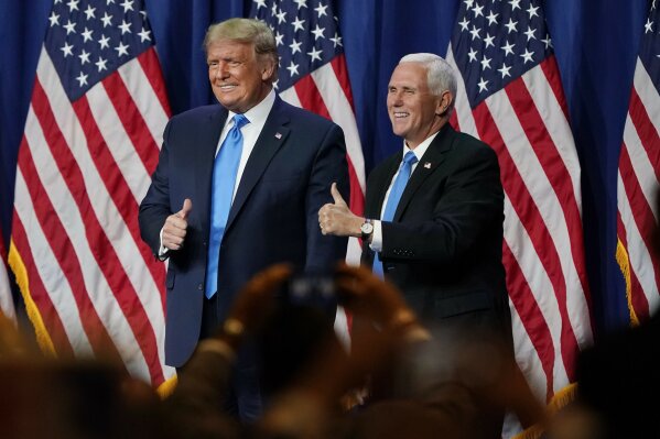 FILE - In this Aug. 24, 2020 file photo President Donald Trump and Vice President Mike Pence give a thumbs up after speaking during the first day of the Republican National Convention in Charlotte, N.C.  Four people who were at the Republican National Convention in Charlotte have tested positive for the coronavirus, health officials in North Carolina’s Mecklenburg County said. WBTV reported Friday, Aug. 28, that those who tested positive at the event were immediately isolated. (AP Photo/Chris Carlson, File)