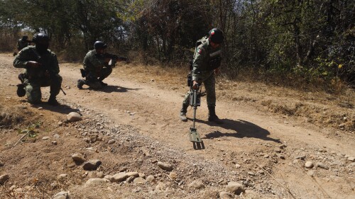 FILE - Mexican Army soldiers demonstrate a search for anti-personnel mines during a media presentation near Naranjo de Chila, in the municipality of Aguililla, Michoacan state, Mexico, Feb. 18, 2022. Authorities say that a coordinated series of roadway bomb blasts on July 11, 2023 in Tlajomulco, Jalisco state killed four police officers and two civilians, as well as wounded 14 others. (AP Photo/Armando Solis, File)