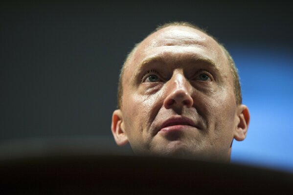 FILE - In this July 8, 2016 file photo, Carter Page, an adviser to U.S. Republican presidential candidate Donald Trump, speaks at the graduation ceremony for the New Economic School in Moscow, Russia.    (AP Photo/Pavel Golovkin)