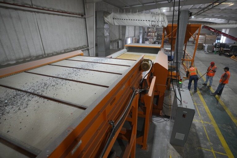 A sorting machine breaks down solar panels at We Recycle Solar on Tuesday, June 6, 2023, in Yuma, Ariz. (AP Photo/Gregory Bull)