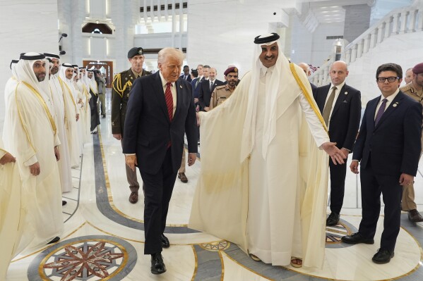 Qatars Emir Sheikh Tamim bin Hamad Al Thani greets President Donald Trump during an official welcome ceremony in the Amiri Diwan in Doha, Qatar, Wednesday, May 14, 2025 (AP Photo/Alex Brandon)