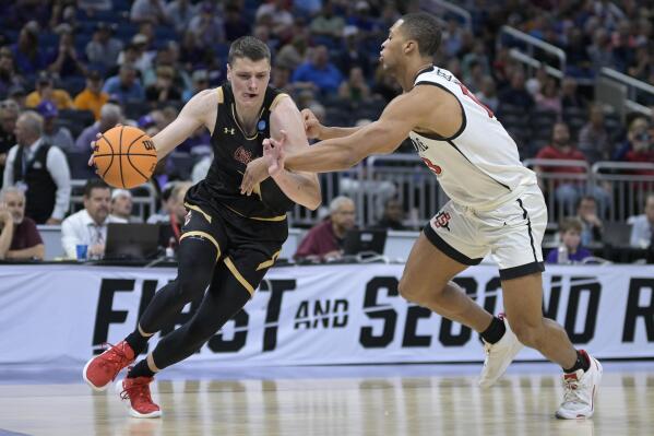 Charleston forward Ante Brzovic, left, drives as San Diego State forward Jaedon LeDee (13) defends during the first half of a first-round college basketball game in the NCAA Tournament, Thursday, March 16, 2023, in Orlando, Fla. (AP Photo/Phelan M. Ebenhack)