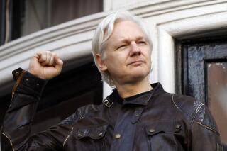 FILE - In this Friday May 19, 2017 file photo, Julian Assange greets supporters outside the Ecuadorian embassy in London. Britain’s High Court on Wednesday July 7, 2021, has granted the U.S. government permission to appeal a decision that WikiLeaks founder Julian Assange cannot be sent to the United States to face espionage charges. (AP Photo/Frank Augstein, File)