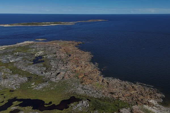 The Churchill River, left, empties into the Hudson Bay, right, Thursday, Aug. 8, 2024, near Churchill, Manitoba. (AP Photo/Joshua A. Bickel)