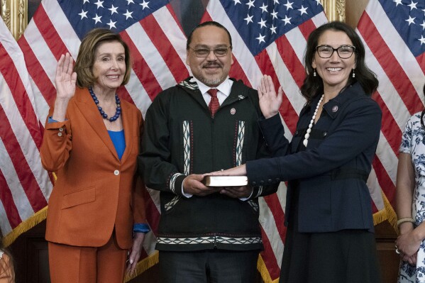 FILE - Speaker of the House Nancy Pelosi of Calif., left, administers the House oath of office to Rep. Mary Peltola, D-Alaska, standing next to her husband Eugene "Buzzy" Peltola Jr., center, during a ceremonial swearing-in on Capitol Hill in Washington, Tuesday, Sept. 13, 2022. Peltola's husband Eugene has died in an airplane crash in Alaska, her office said Wednesday, Sept. 13, 2023. ( AP Photo/Jose Luis Magana, File)