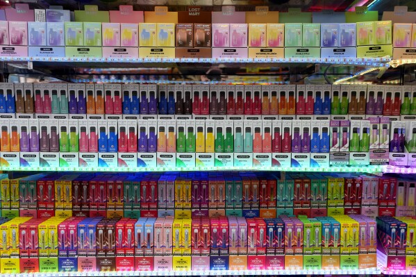 A selection of colourful disposable vapes on display for sale in a souvenir shop in London, Monday, Jan. 29, 2024. The British government says it will ban the sale of disposable vapes and limit their cornucopia of flavors in an effort to prevent children becoming addicted to nicotine. It also says it will stick to a contentious proposal to ban today’s young people from ever buying cigarettes. (AP Photo/Kirsty Wigglesworth)