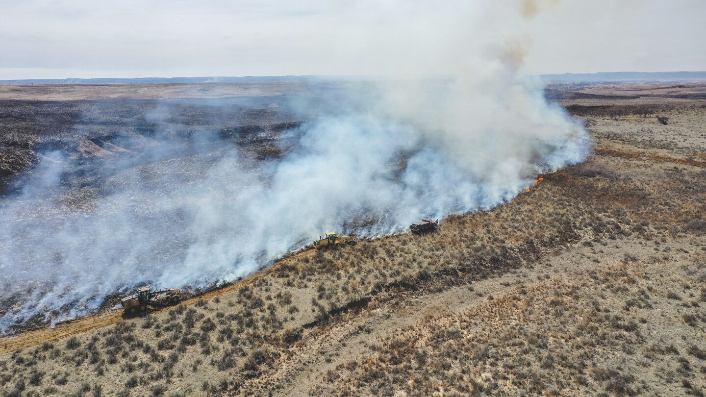 Texas firefighters battle flames stoked by strong winds as warnings are issued across the region