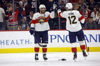Florida Panthers' Aleksander Barkov (16) congratulates Eric Staal (12) following overtime in Game 2 of the NHL hockey Stanley Cup Eastern Conference finals against the Carolina Hurricanes in Raleigh, N.C., Saturday, May 20, 2023. (AP Photo/Karl B DeBlaker)