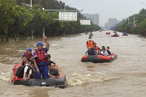 Residents are evacuated by rubber boats through flood waters in Zhuozhou in northern China's Hebei province, south of Beijing, Wednesday, Aug. 2, 2023. China's capital has recorded its heaviest rainfall in at least 140 years over the past few days. Among the hardest hit areas is Zhuozhou, a small city that borders Beijing's southwest. (AP Photo/Andy Wong)