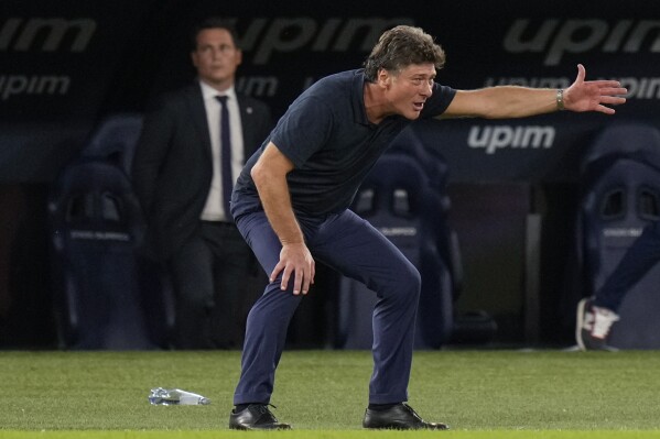 FILE - Cagliari head coach Walter Mazzarri gives instructions during the Serie A soccer match between Lazio and Cagliari, at the Rome Olympic stadium, on Sept. 19, 2021. Napoli is in crisis just six months after storming to its first Serie A title since the days when Diego Maradona played for the club. The southern club has fired coach Rudi Garcia and replaced him with Walter Mazzarri. The 62-year-old Mazzarri returns to Napoli 10 years after leading it to runner-up spot in the Italian league. (AP Photo/Alessandra Tarantino, File)