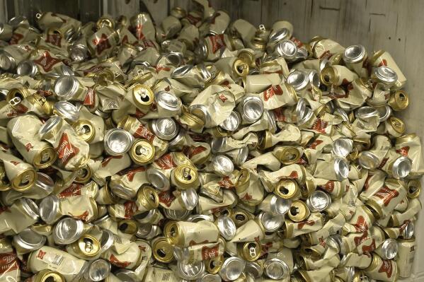 In this image provided by Comite Champagne, cans of Miller High Life beer sit in a container after being crushed at the Westlandia plant in Ypres, Belgium, Monday, April 17, 2023. Belgian customs have destroyed more than 2,000 cans of Miller High Life advertised as the ″Champagne of beers” at the request of houses and growers of the bubbly beverage. (Comite Champagne via AP)