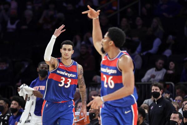Washington Wizards forward Kyle Kuzma (33) and teammate Spencer Dinwiddie gesture after Kuzma's 3-pointer during the second half of the team['s NBA basketball game against the New York Knicks on Thursday, Dec. 23, 2021, in New York. (AP Photo/Adam Hunger)