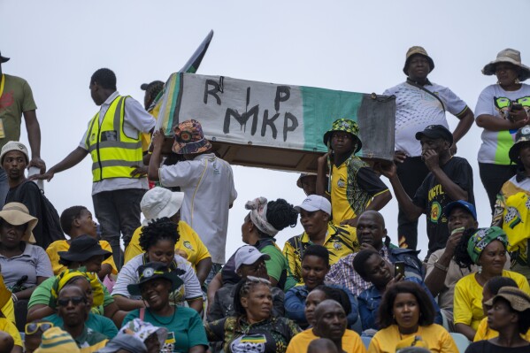 African National Congress supporters carry a mock coffin of former President Jacob Zuma as they gather at the Mose Mabhida stadium in Durban, South Africa, Saturday, Feb. 24, 2024, for their national manifesto launch in anticipation of the 2024 general elections. (AP Photo/Jerome Delay)