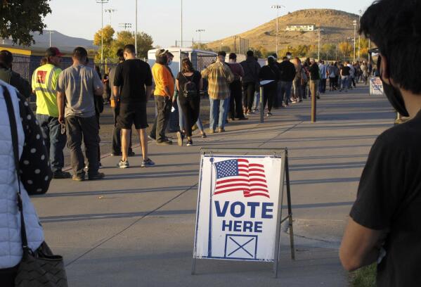 FILE - People wait to vote in-person at Reed High School in Sparks, Nev., prior to polls closing on Nov. 3, 2020. Nevada voters on Tuesday, Nov. 8, 2022 decided to adopt what is widely considered the most comprehensive state version of the Equal Rights Amendment, a sweeping update that could put protections in place for people who have historically been marginalized in the state Constitution. (AP Photo/Scott Sonner, File)