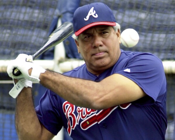 FILE - Atlanta Braves coach Pat Corrales hits ground balls during batting practice Oct. 11, 2001, at Turner Field in Atlanta. Corrales, who managed the Texas Rangers, Cleveland Indians and Philadelphia Phillies before a long stint on the Braves coaching staff under Hall of Fame skipper Bobby Cox, has died at age of 82. (AP Photo/Ric Feld, File)